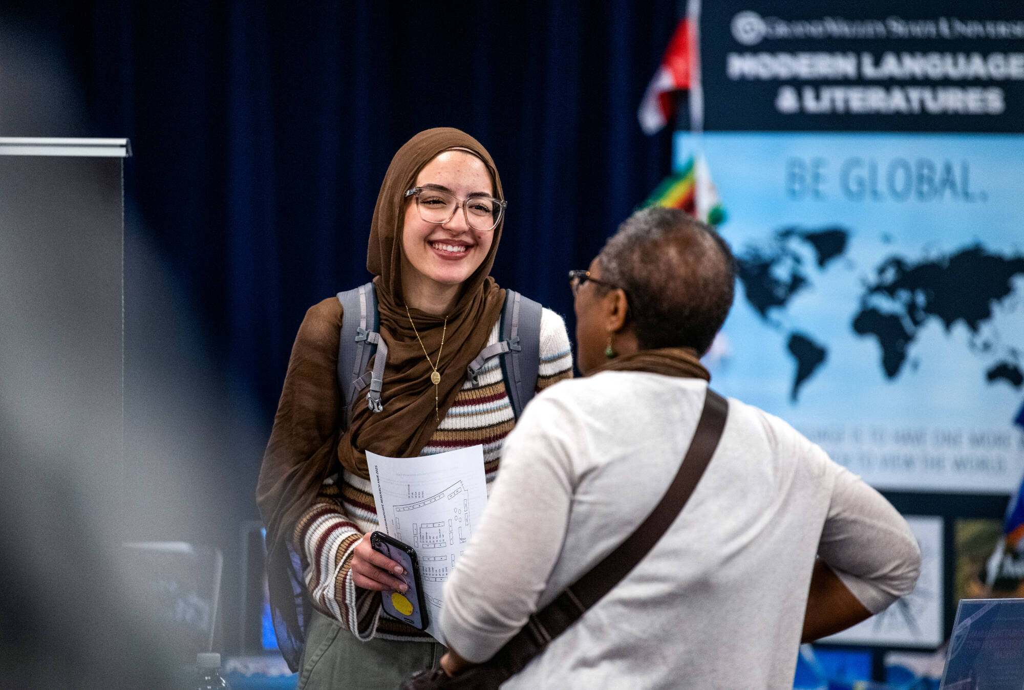 Mai Sanour, a first-year biomedical sciences major, visits tables of faculty and staff from academic departments and research groups.